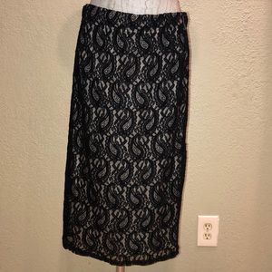 Kneelength black lace paisley skirt.